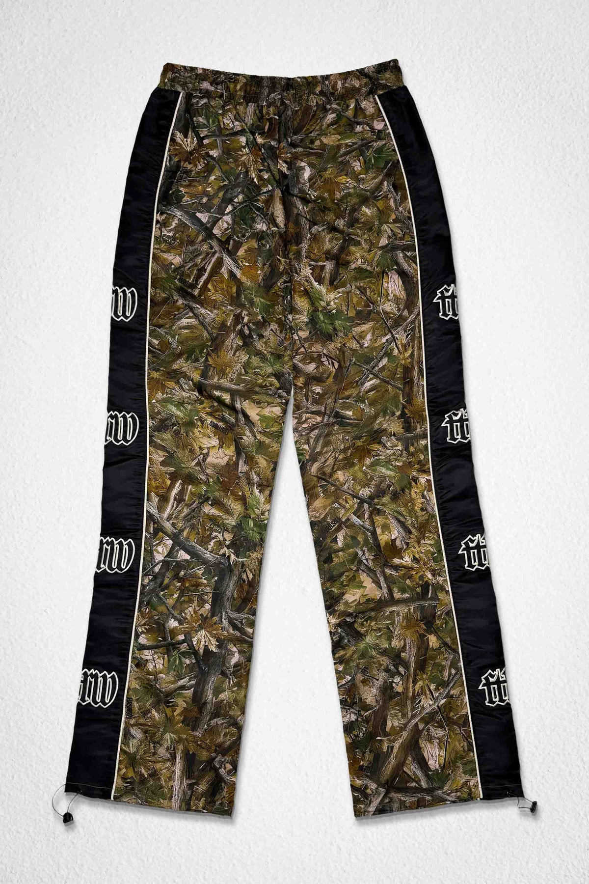 Men's camo nylon paneled track pants with patch detail