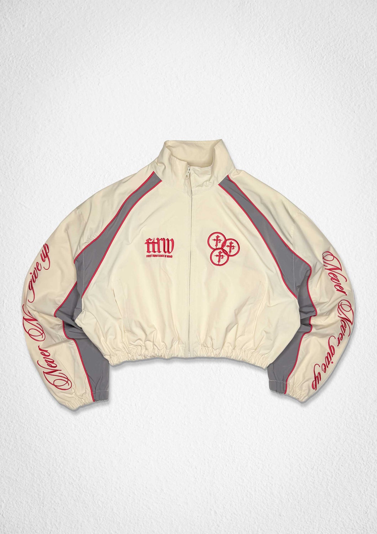 Men's ecru cropped zip track jacket with paneled body and varsity-style patch details - front