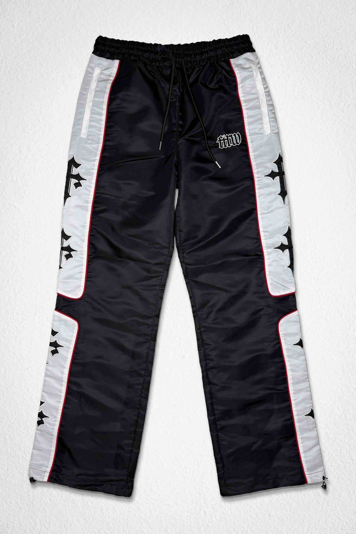 Men's black nylon paneled track pants with patch detail