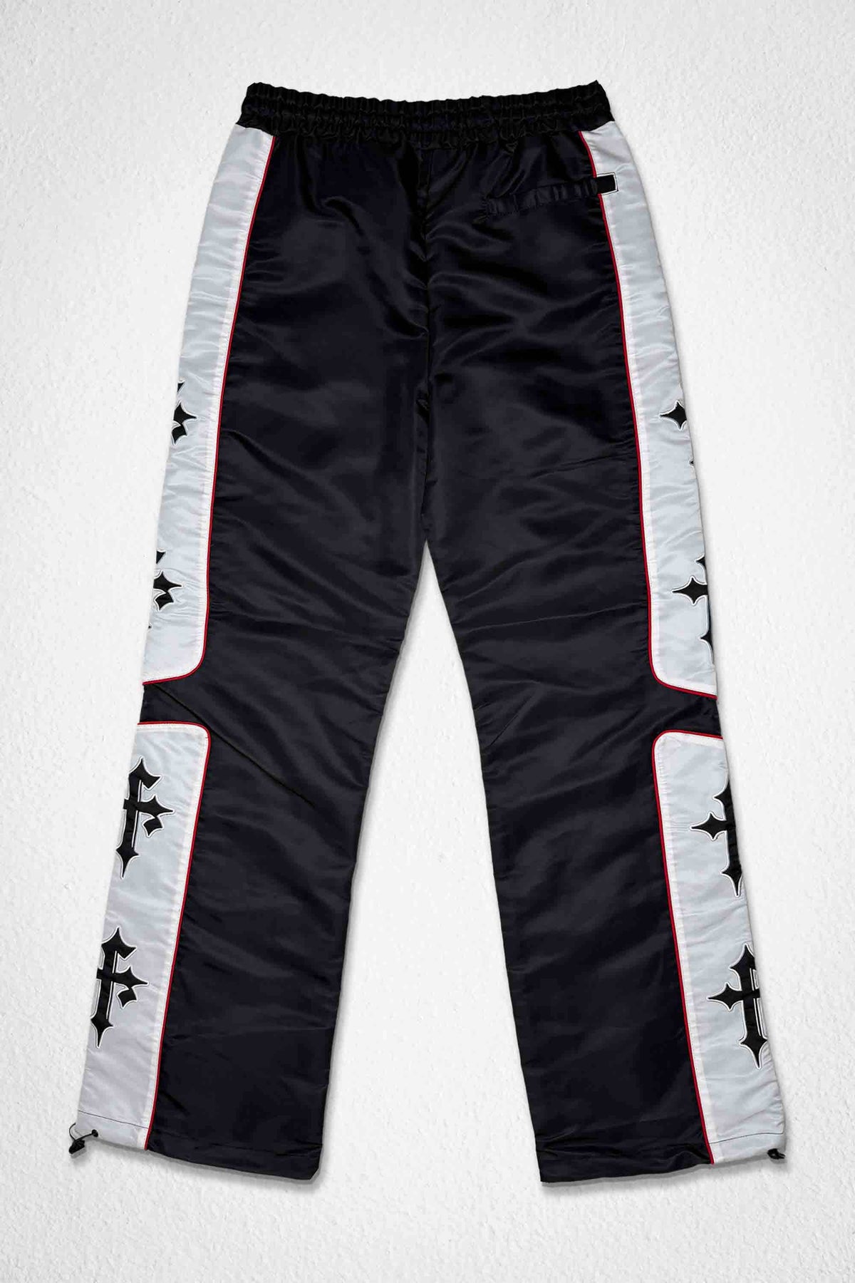 Men's black nylon paneled track pants with patch detail