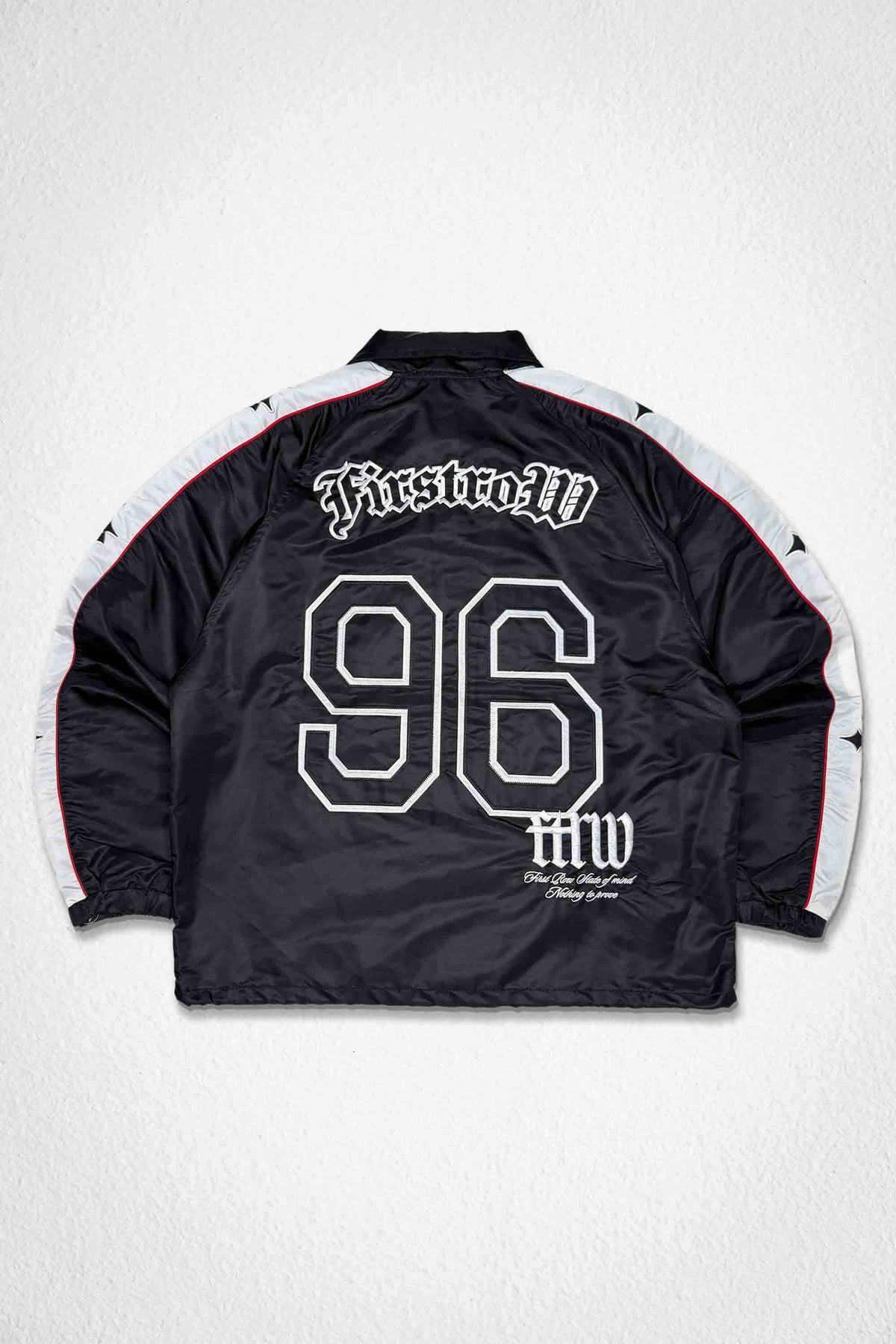 Men's black nylon coach jacket with racer-style panels and patch details
