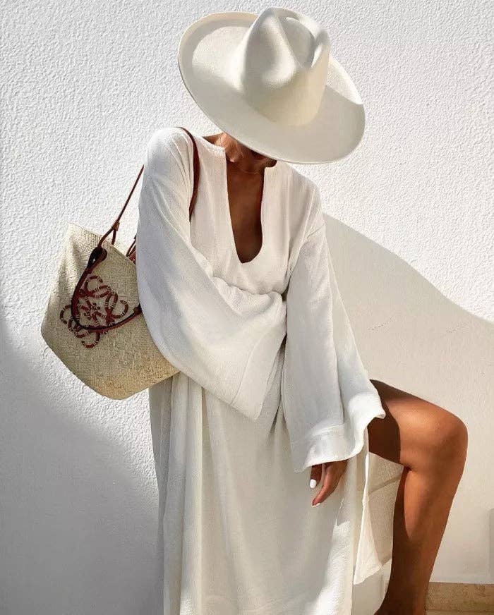 Women's deep V-neck flared sleeve midi dress in white or black – styled view