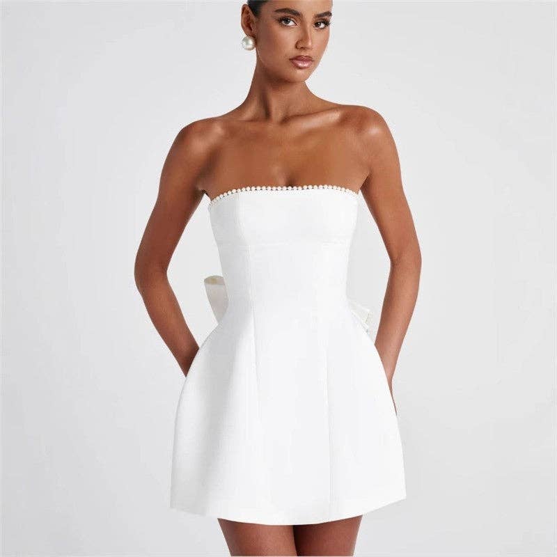 Women's pink pearl bow strapless fitted mini dress – styled view