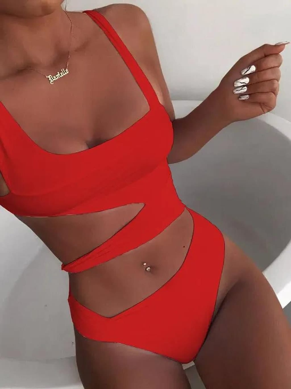 Woman wearing the Cutting It cutout one-piece swimsuit
