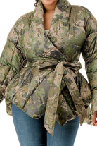 Women's plus size camo puffer jacket with belt on model