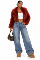 Women's burgundy faux fur cropped coat on model