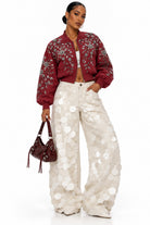 Women's white sequin embellished jeans on model