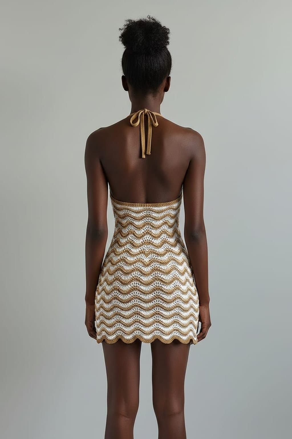 Woven dress on a mannequin against a beige background