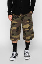 Camouflage cargo shorts worn by a person on a white background