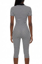 A black and white horizontally striped short-sleeve bodycon jumpsuit shown from the back on a white mannequin against a white background.