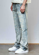 Men's medium stone flare jeans with allover rhinestones and rip and repair