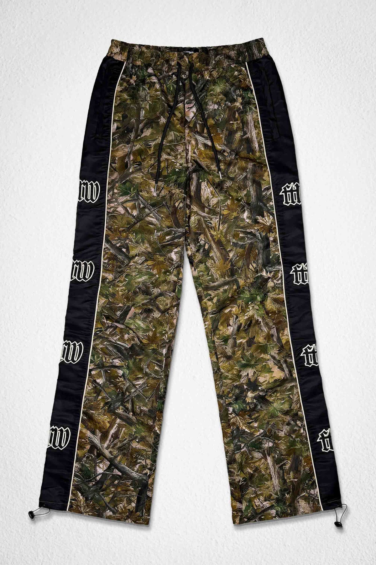 Men's camo nylon paneled track pants with patch detail