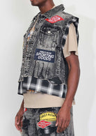 Men's black stone wash distressed cut-off denim vest with plaid and multi patches