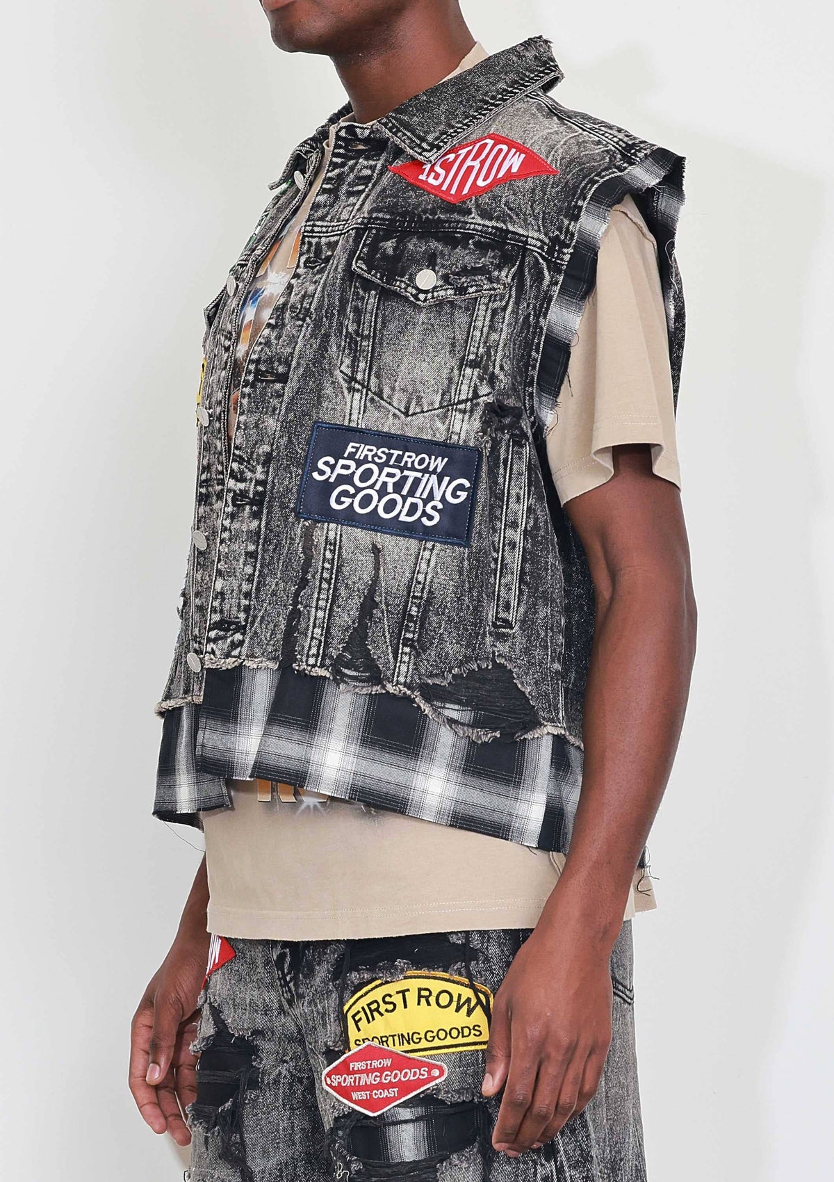 Men's black stone wash distressed cut-off denim vest with plaid and multi patches
