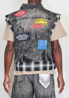 Men's black stone wash distressed cut-off denim vest with plaid and multi patches