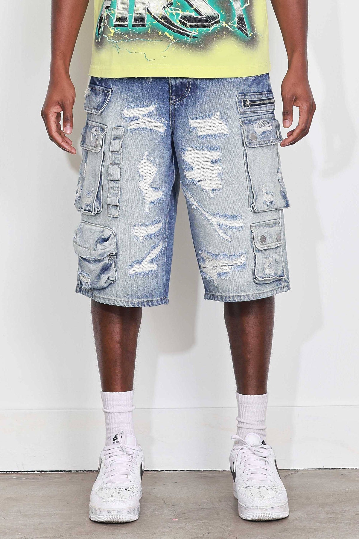Men's medium blue distressed denim cargo jorts with raw hem