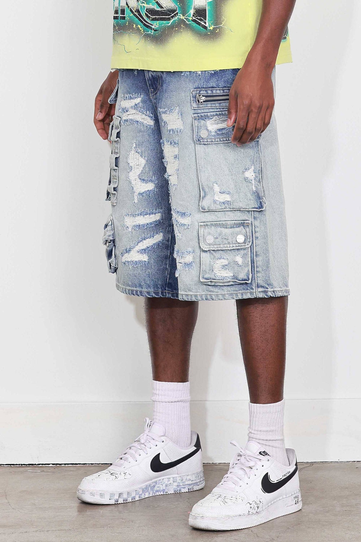 Men's medium blue distressed denim cargo jorts with raw hem