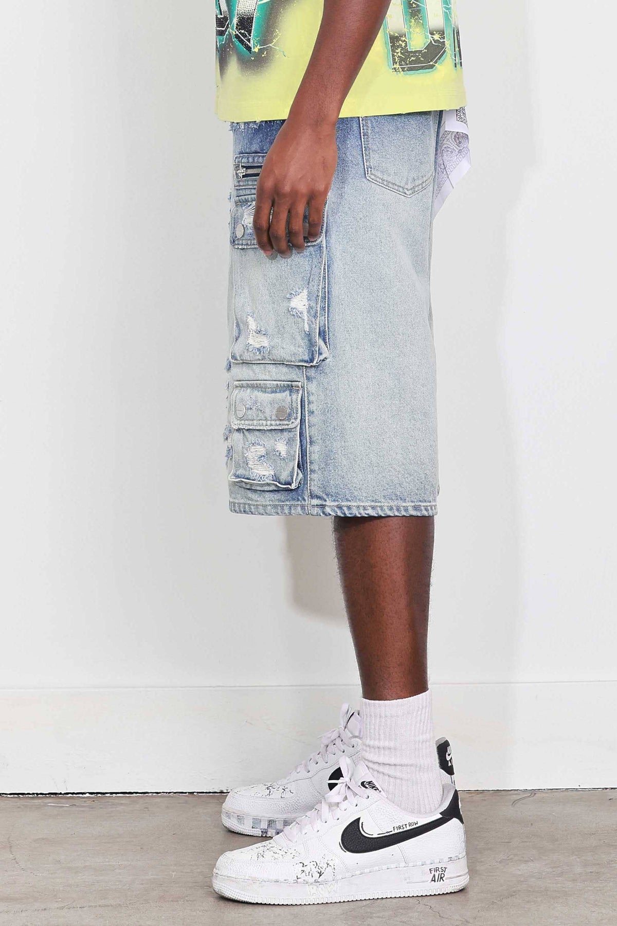 Men's medium blue distressed denim cargo jorts with raw hem