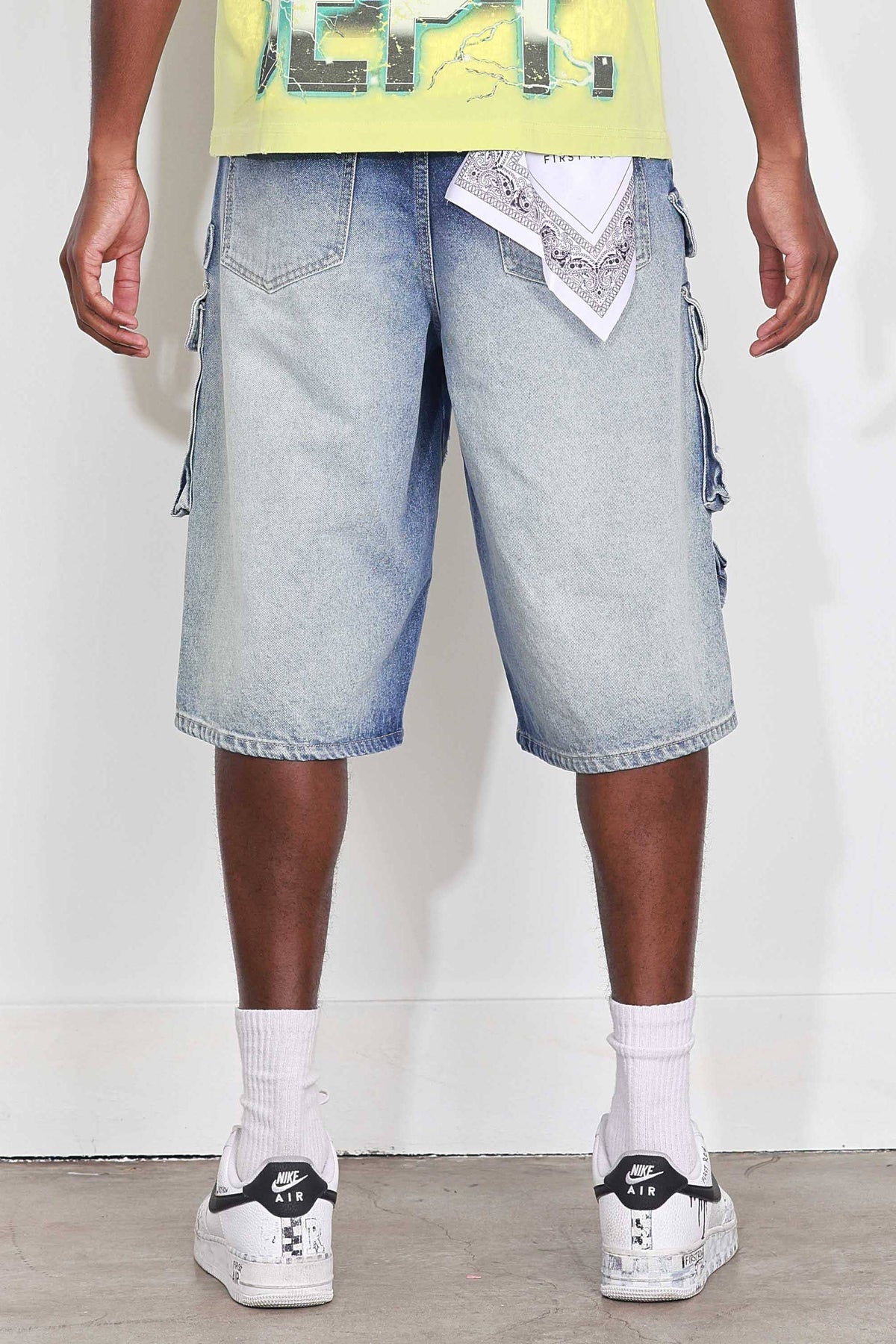 Men's medium blue distressed denim cargo jorts with raw hem