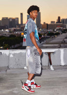 Men's grey stone denim cargo jorts with ink splatter detail