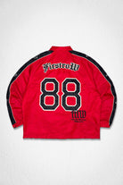 Men's red nylon coach jacket with paneled body and patch details