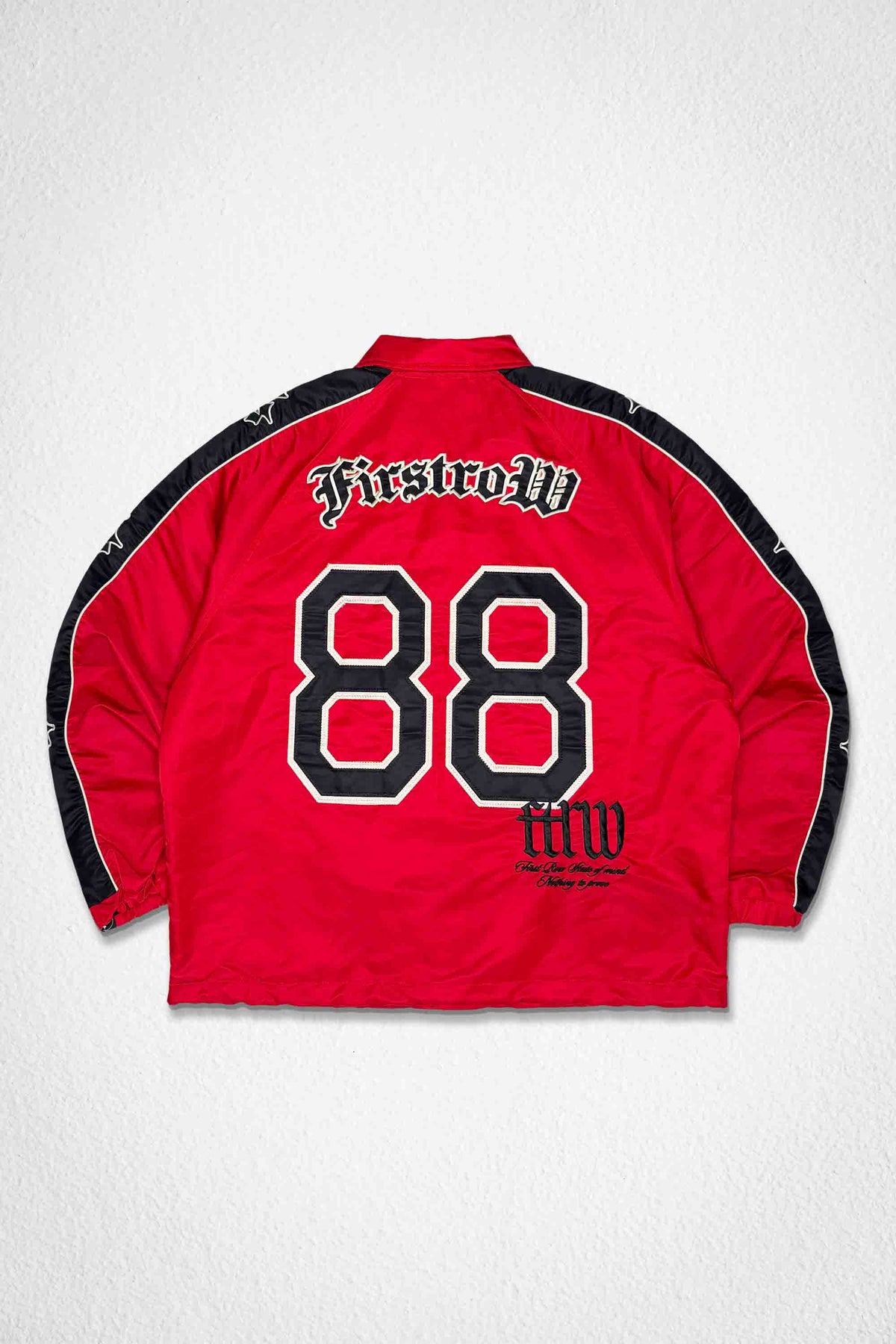 Men's red nylon coach jacket with paneled body and patch details