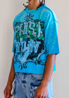 Men's teal blue cropped terry tee with rhinestone frame graphic