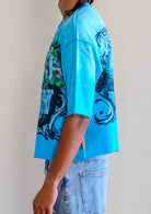 Men's teal blue cropped terry tee with rhinestone frame graphic