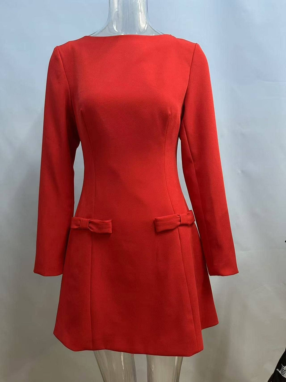 Women's red long sleeve boat neck mini dress with bow detail