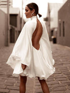 Women's high neck backless flared sleeve mini dress in black or white – front view