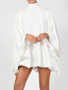 Women's high neck backless flared sleeve mini dress in black or white – styled view