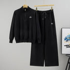 Women's black ribbed half-zip sweater and wide-leg knit pant set – front view